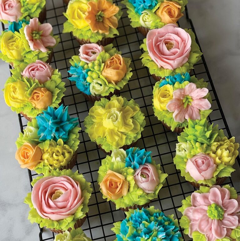 Cupcakes decorated with frosting flowers.