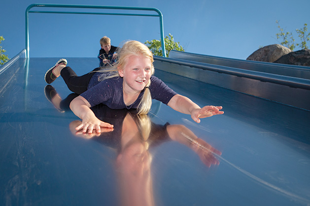 A girl slides down a slide at Central Park in Maple Grove.