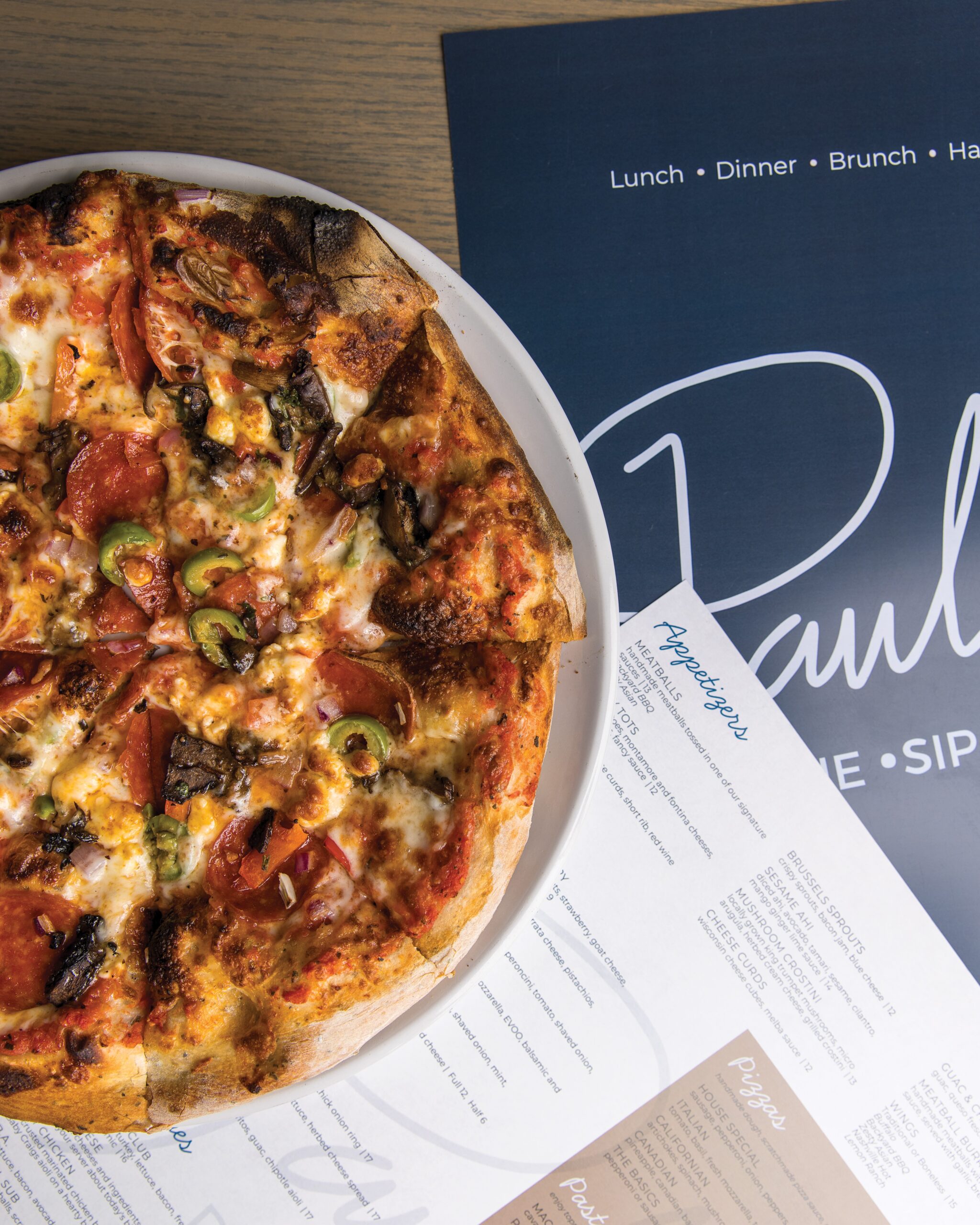 Pizza and menus from Paulie's.