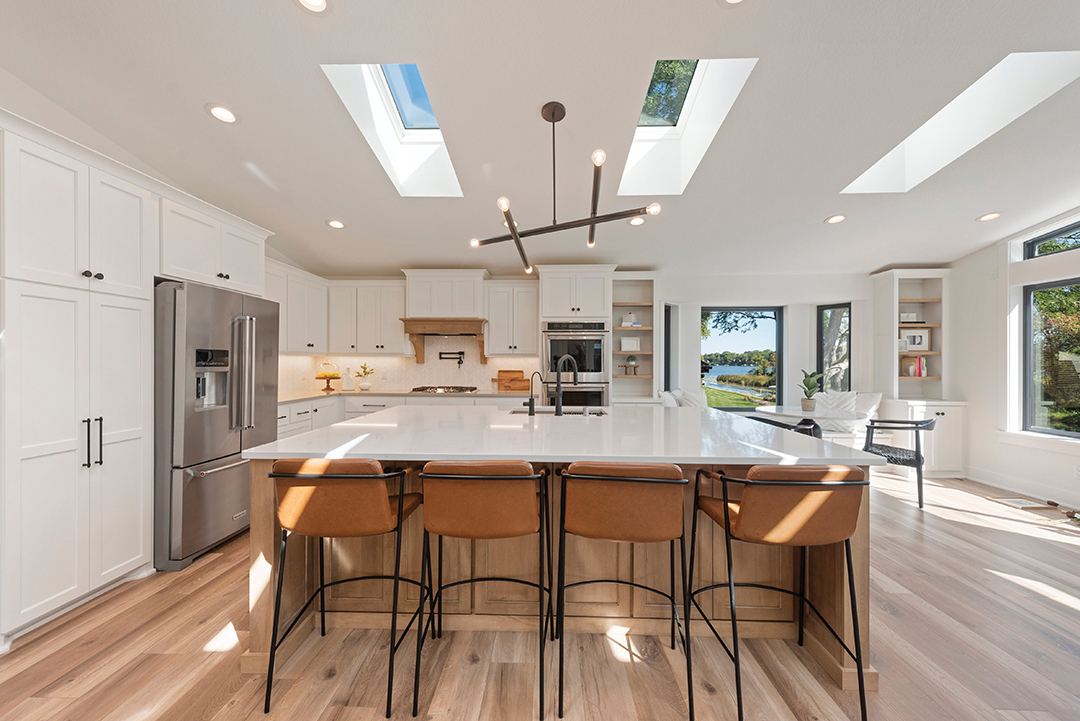 Kitchen island lit by skylights.