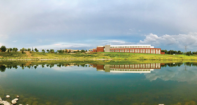 A shot of the Maple Grove Government Center reflected in a nearby body of water.