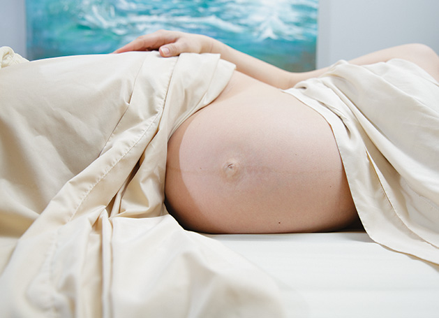 Pregnant woman receives massage.