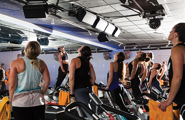 Participants cycle during a class at Surge Cycling in Maple Grove.