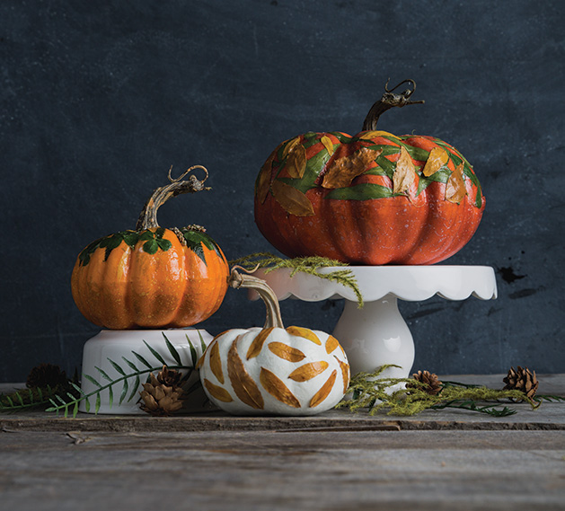 Three hand-decorated pumpkin centerpieces.