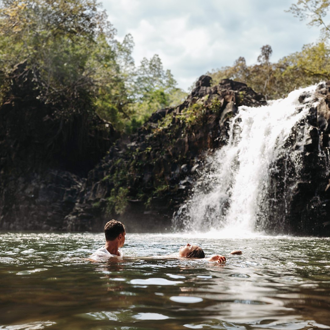 A recently eloped couple celebrating at Twin Falls on the Road to Hana in Maui, Hawaii.