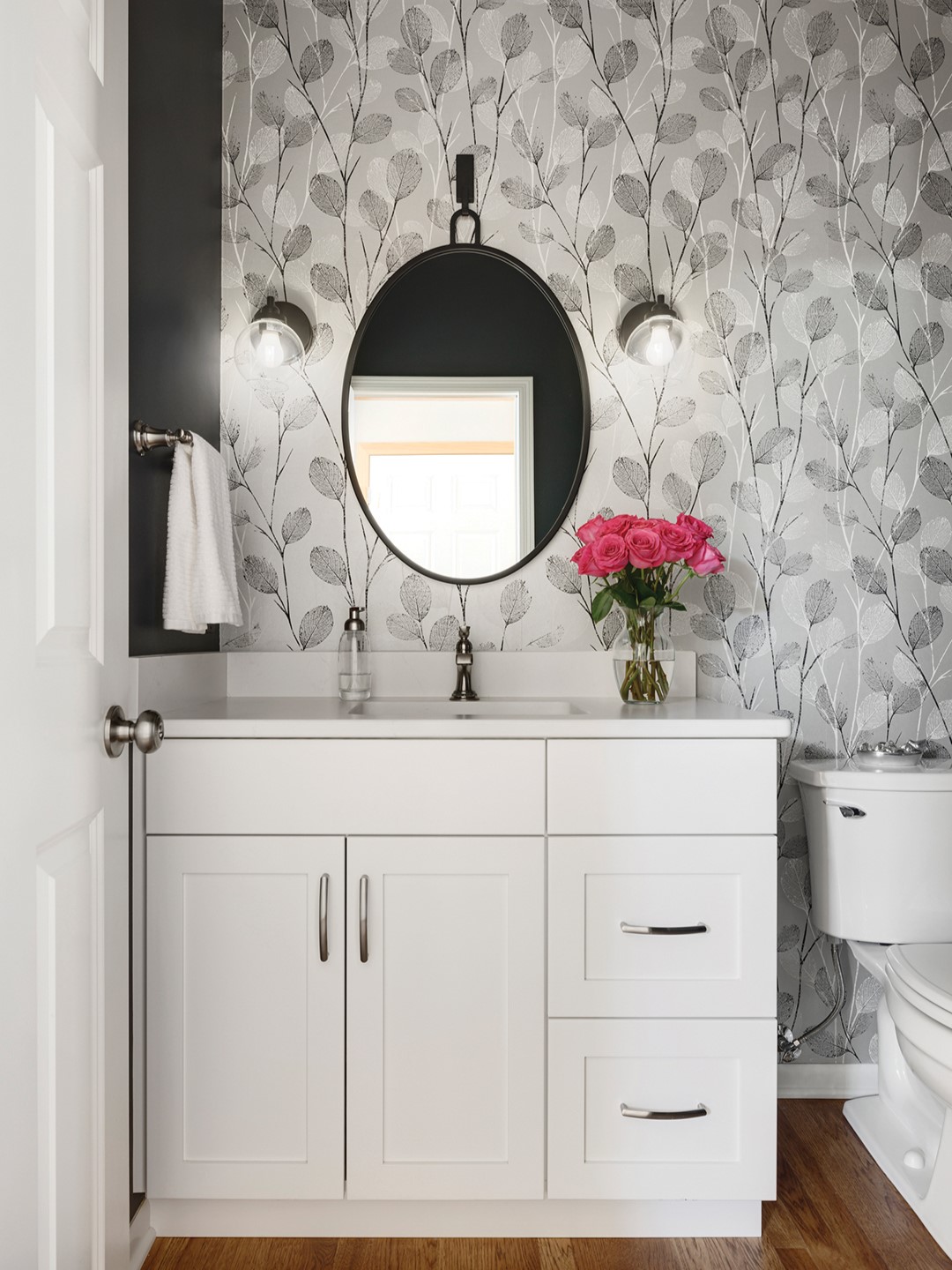 This revamped powder room, with its stunning wallpaper, adds character to the Letourneau home.