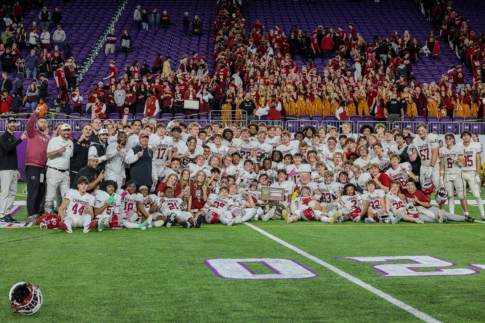 Maple Grove Senior High School Crimson Football team pose for a group photo on the U.S. Bank Stadium field after winning the 2024 6A State Championships. Photos: Jenae Hubbard