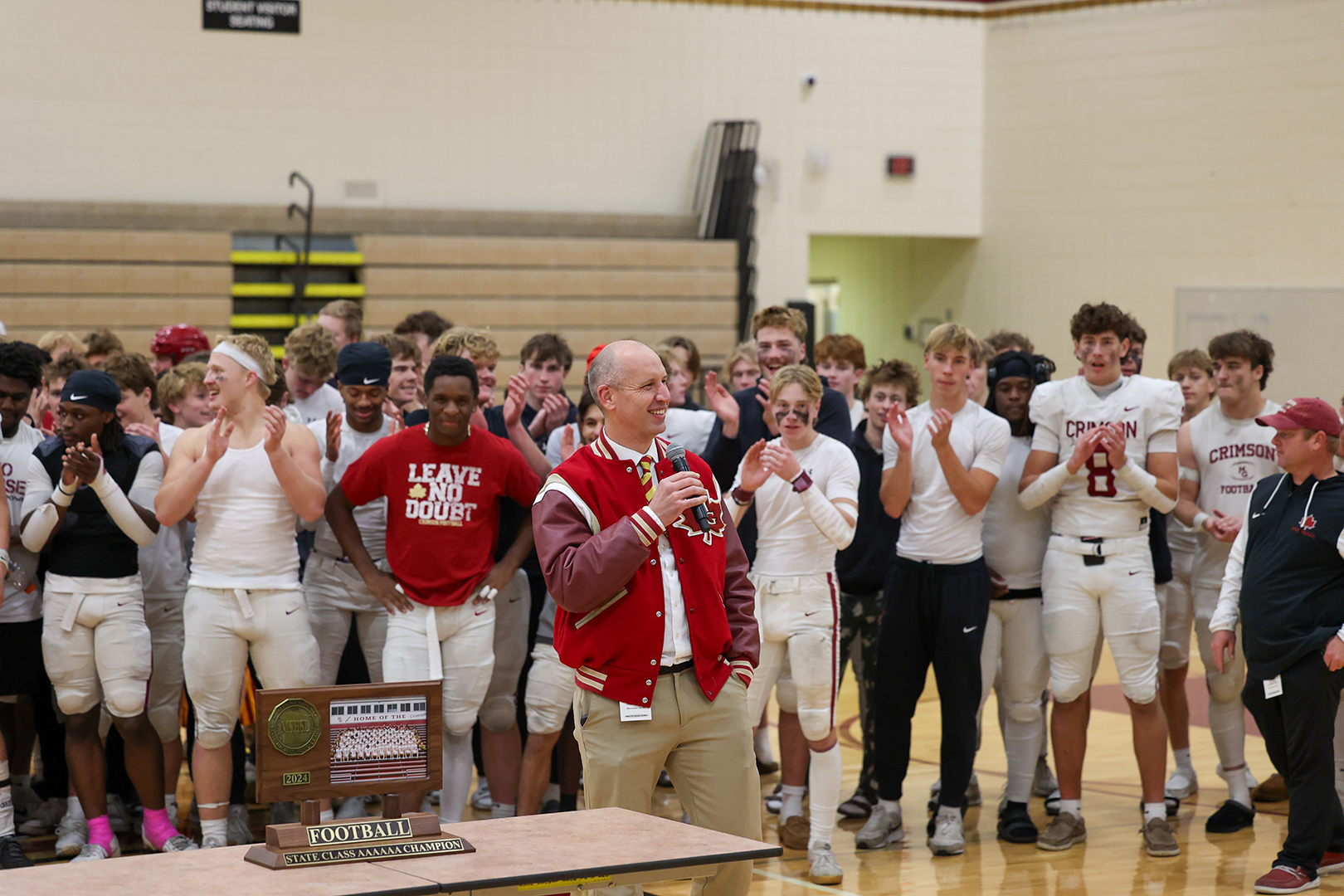 Maple Grove Senior High School principal Bart Becker addresses the team.