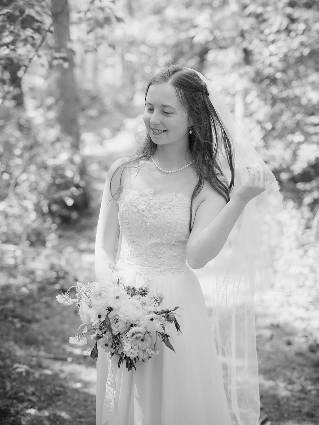 The bride’s vintage dress was purchased and altered at Sienna Cole Bridal. Owner Lisa Ramlet replaced the original skirt with a flowy, organic fabric. Zoe balanced the look with her great-grandmother’s pearl jewelry, secondhand clogs and a blusher veil (also from Sienna Cole).