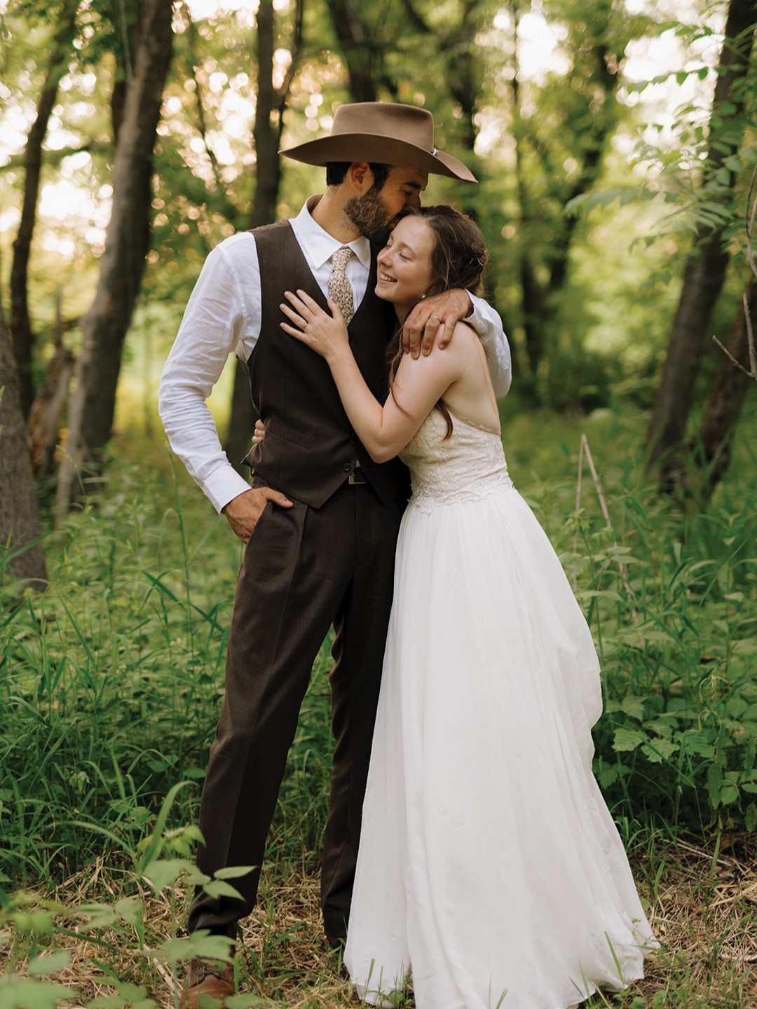 The groom’s brown, three-piece custom suit, from Milbern Clothing Co., was inspired—in fit, style and material—by 1930s cinema stars like Jimmy Stewart. An acorn-patterned tie and boots from Red Wing Shoes completed the look.