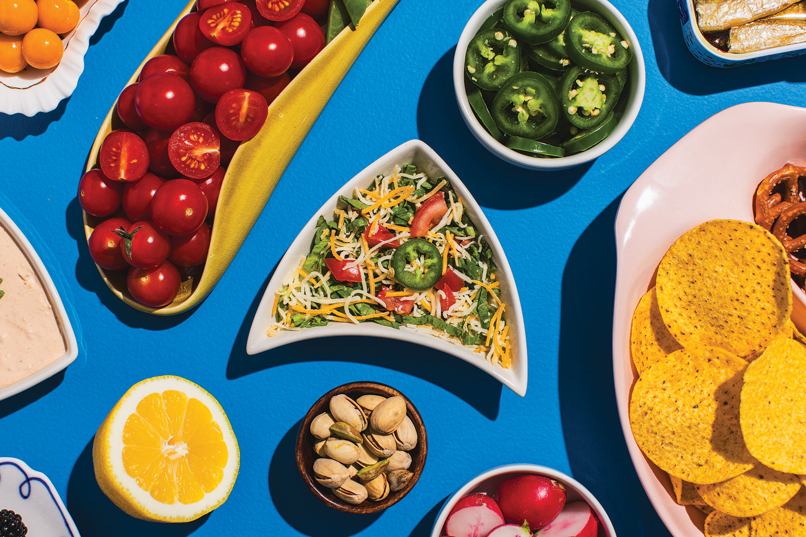Layered Taco Dip surrounded by other appetizers