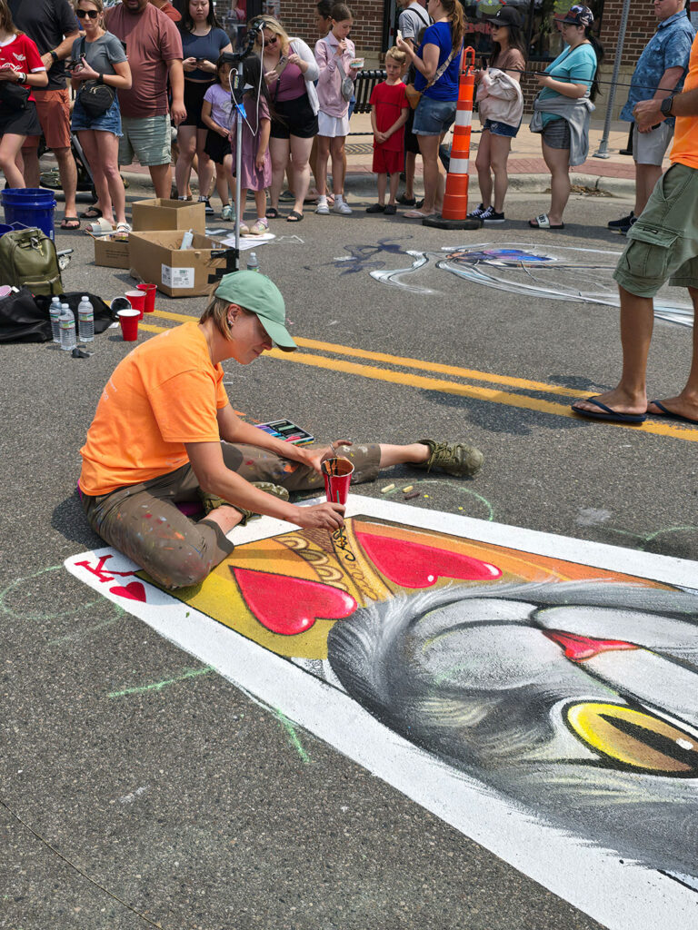 Chalkfest Maple Grove Artist Working on Cat King of Hearts Card Mural