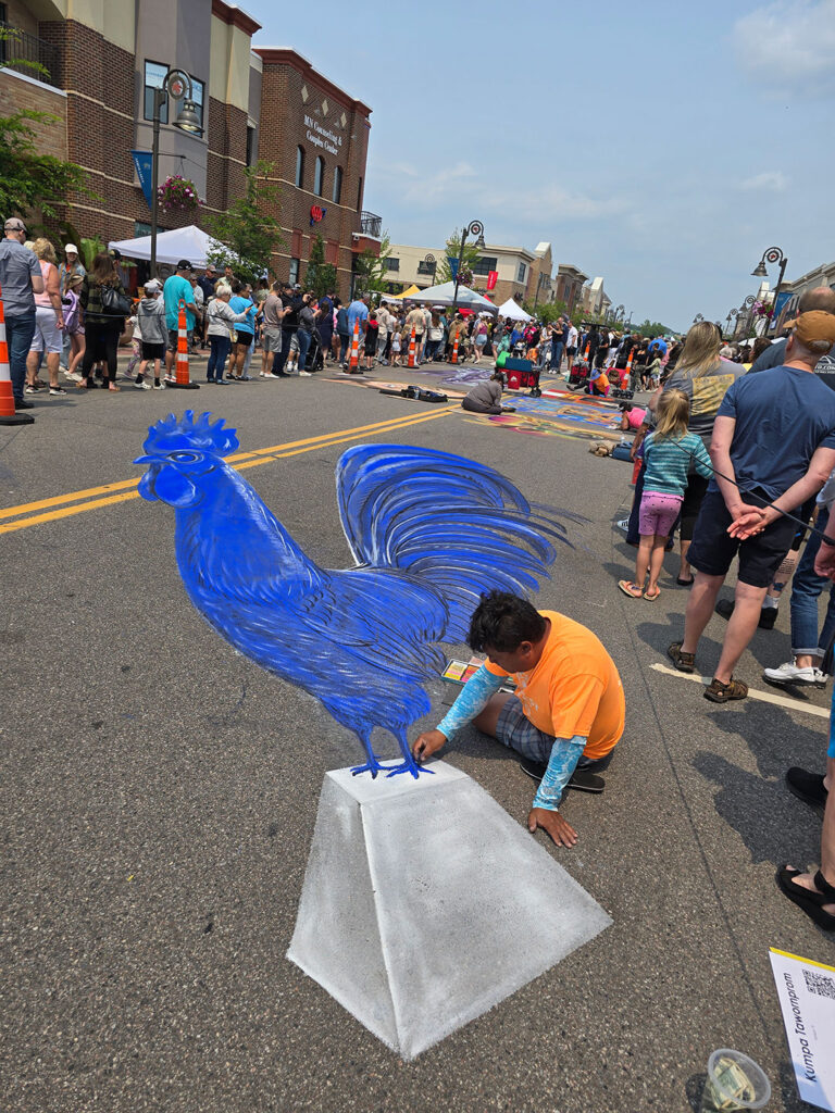 Chalkfest Maple Grove Artist Working on Blue Rooster Mural