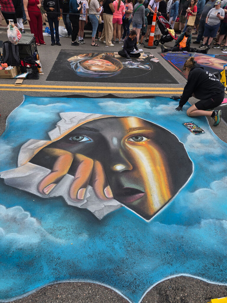 Chalkfest Maple Grove Woman Peering Through a Hole in the Sky Mural