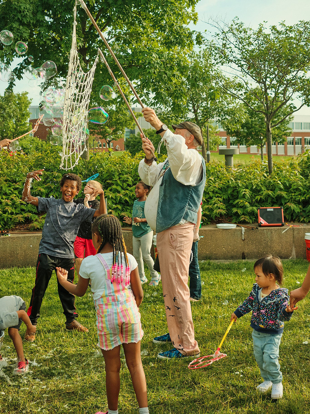 Kids participating in the large bubble activity at Maple Grove's Juneteenth event.