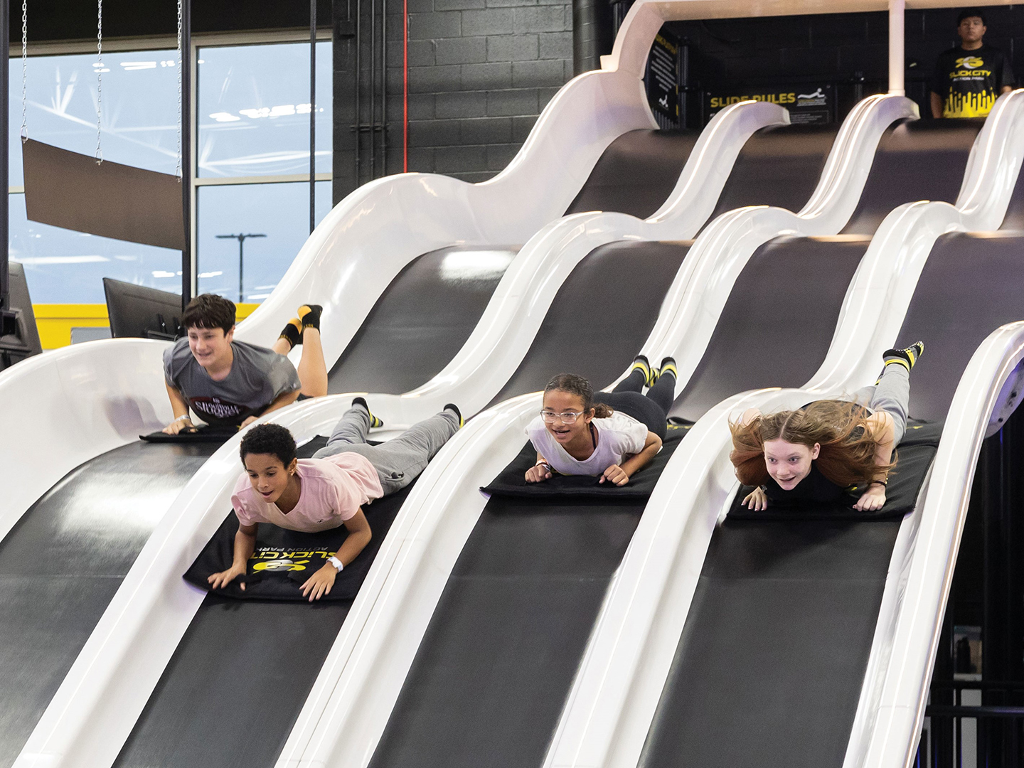 Kids on slides at Slick City
