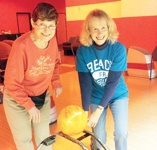 Lynn (left) and Reach staff member Lisa enjoy bowling league together.