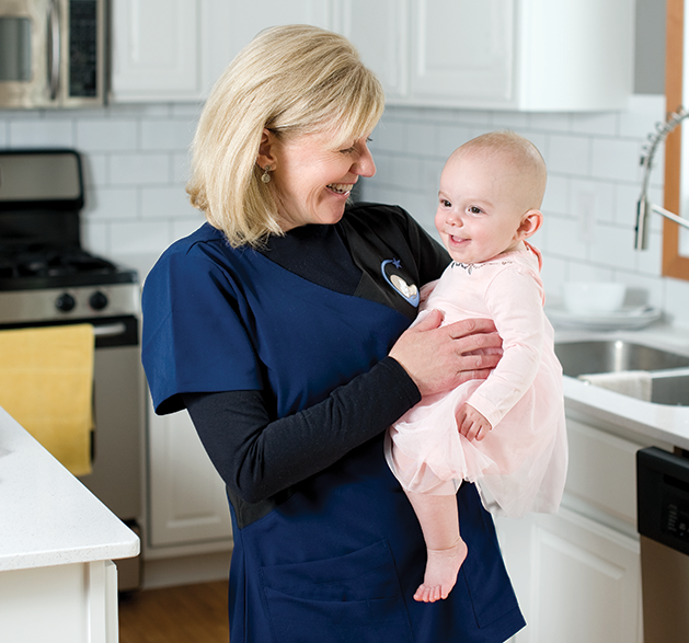 Ellen Roeser, owner of North Star Newborns, with client Melissa Stratton's baby, Liv.