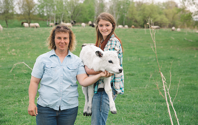 Christina Traeger and her daughter enjoy the expanse of their farm in Avon, MN.