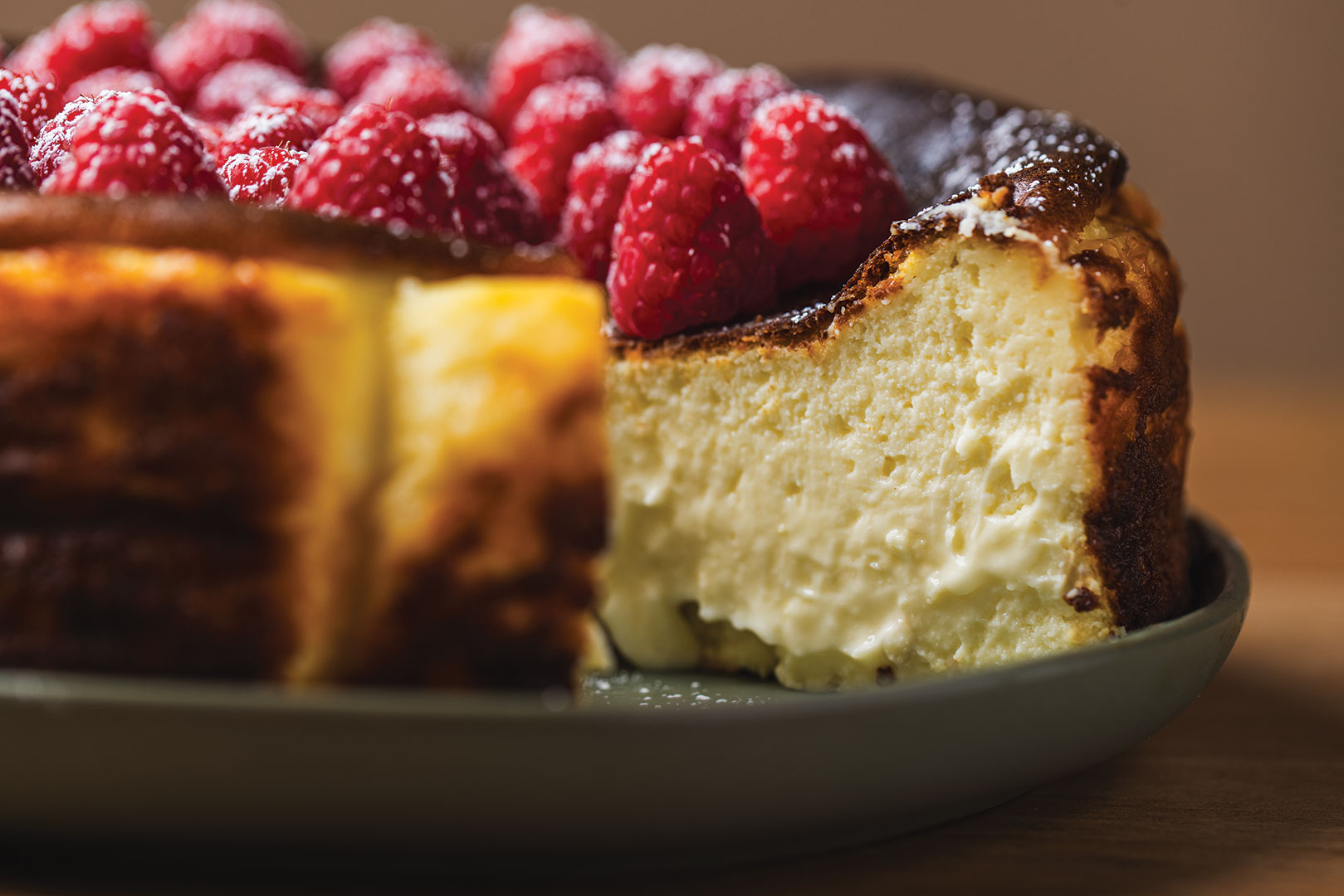 Classic Basque-style cheesecake topped with raspberries.