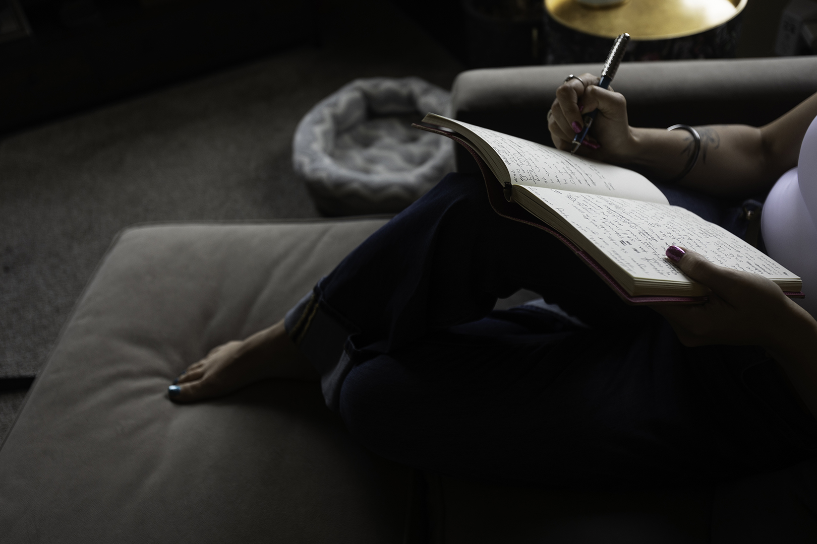 Author Sarah Hanson writing in a notebook