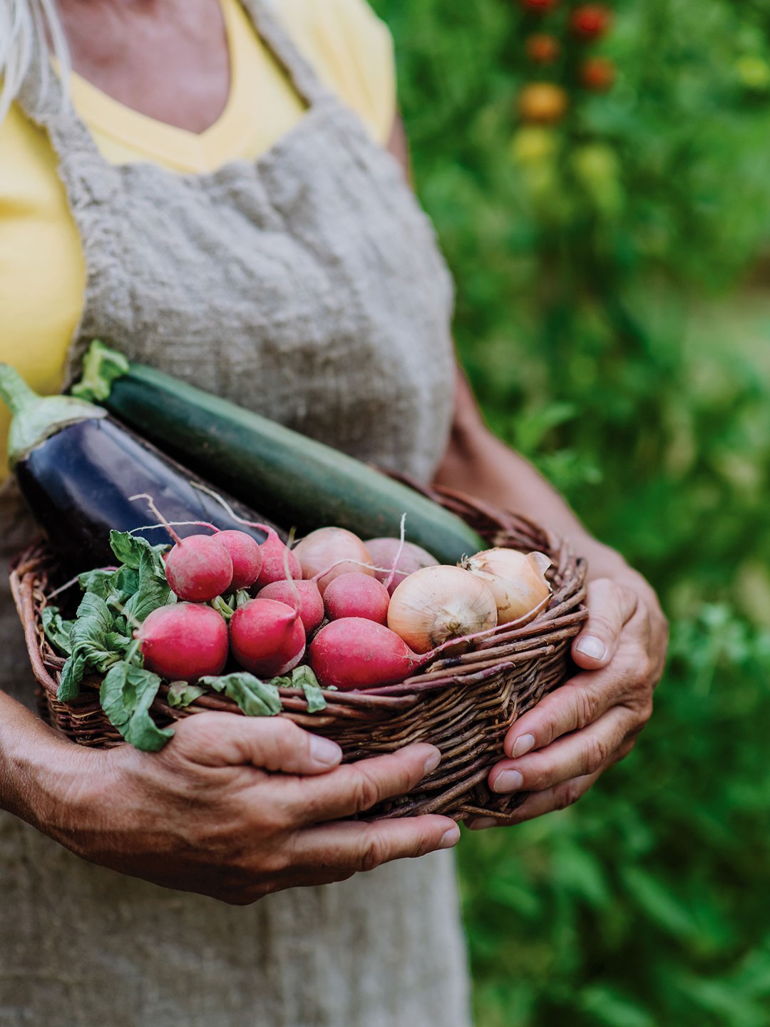 Woman holding basket of vegetables